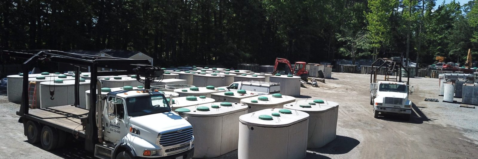 wide view of the work yard with multiple concrete septic tanks